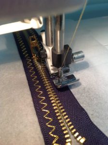 Black zipper with gold stitching
